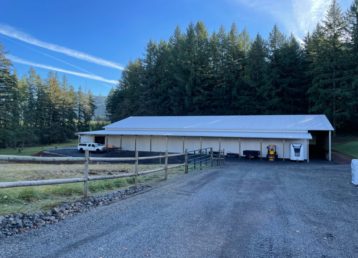 Post frame built agricultural barn