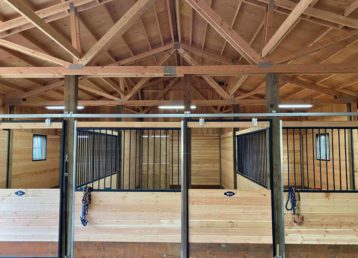 Pole barn riding arena with horse stalls 